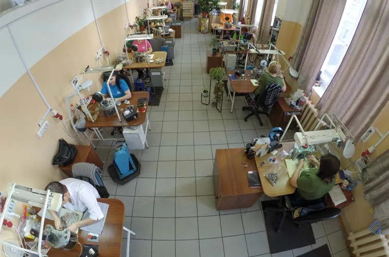 View from above of a workshop with workers at their benches