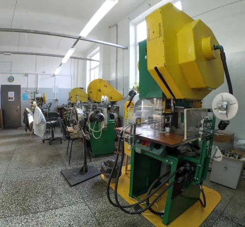 Yellow and green stamping press in the stamping section